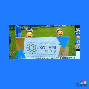 two people holding up a vinyl banner sign